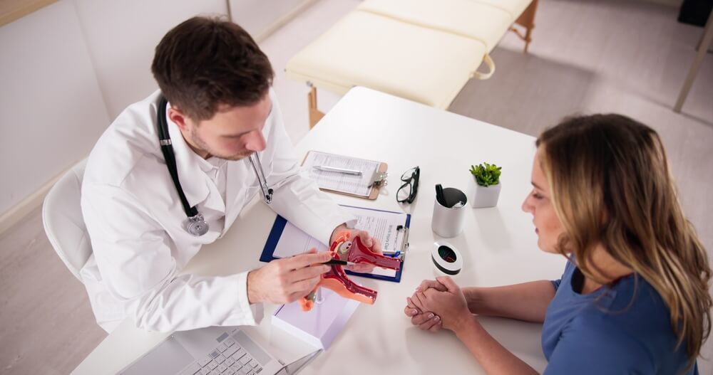 A doctor demonstrating fibroid treatment to a patient