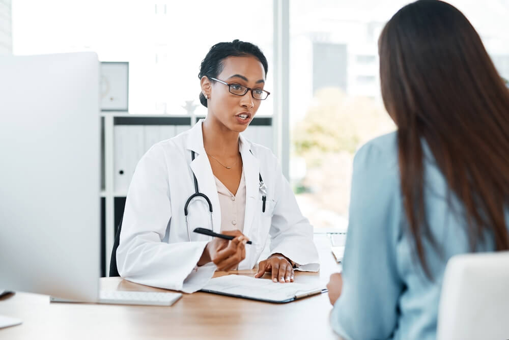 A doctor discussing fibroid treatment options with a patient.