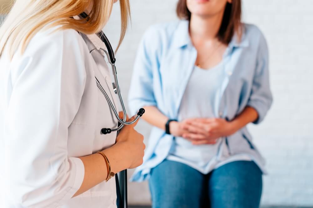 Woman speaks to health professional about health concerns