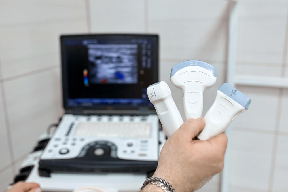 A doctor holding various ultrasound wands for focused ultrasound fibroid treatment