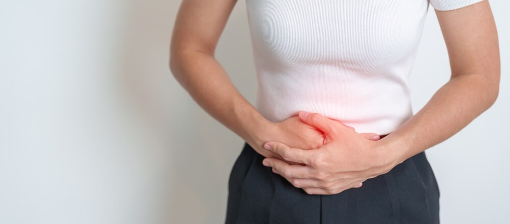 Women clutches her abdomen seeks second opinion hysterectomy